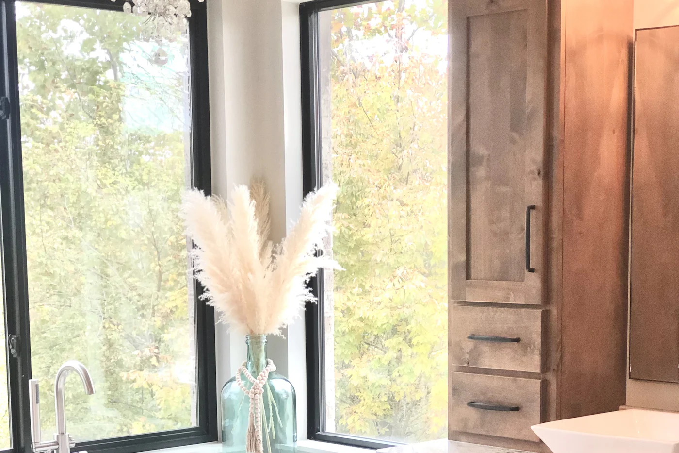 Bathroom with a bath, wooden vanity unit and a window