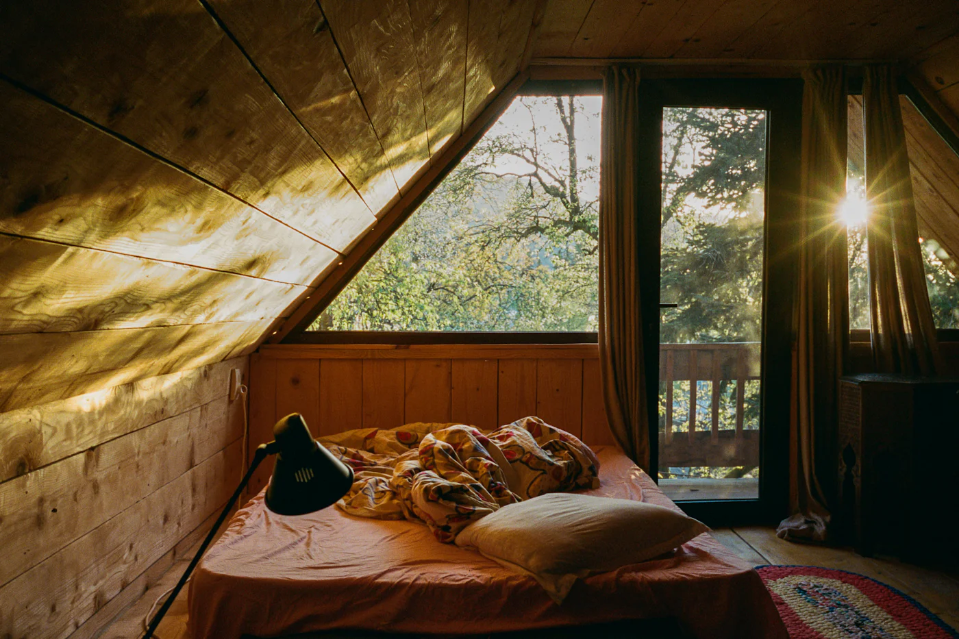 Calm double bedroom with a large window filled with morning light