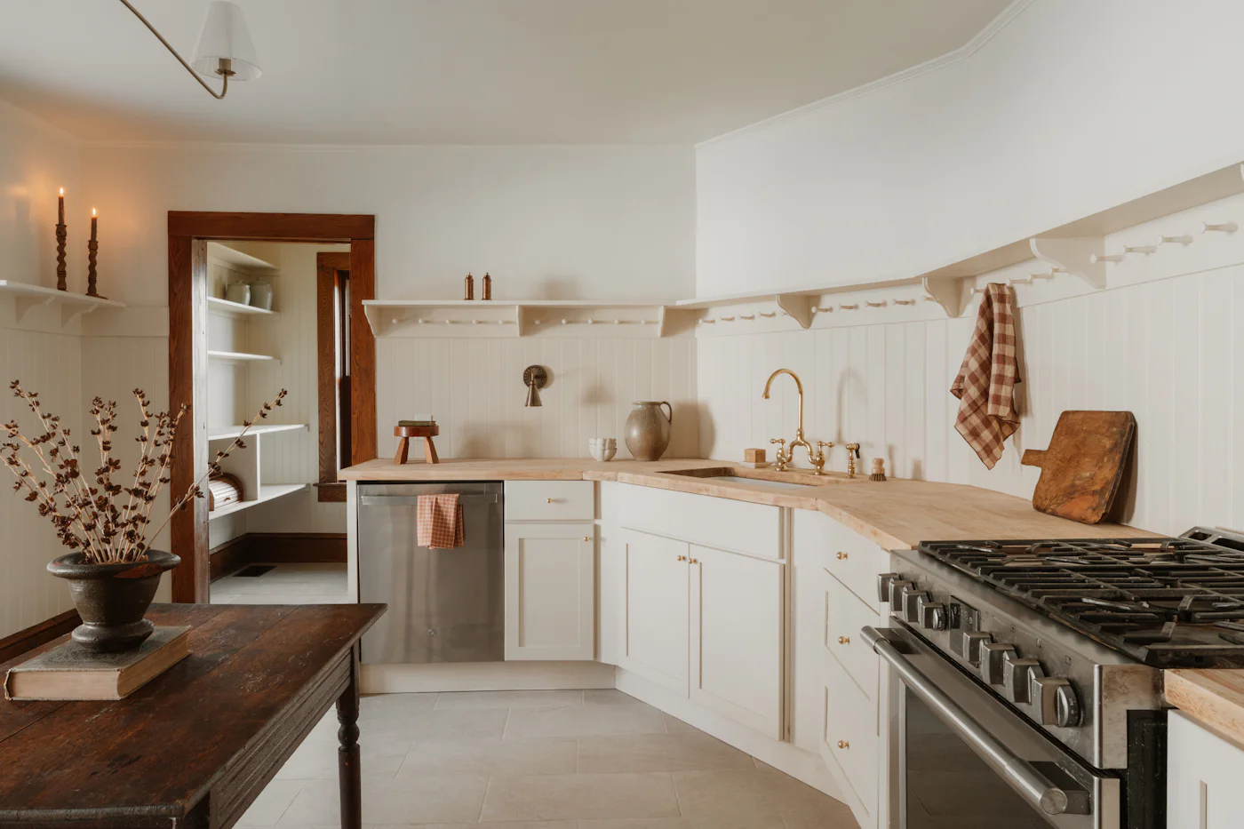 Airy white kitchen with wooden worktops and open shelving