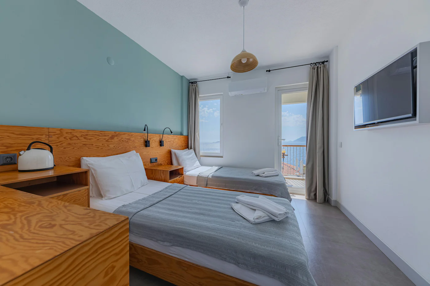 Twin bedroom with two single beds and a view of the sea